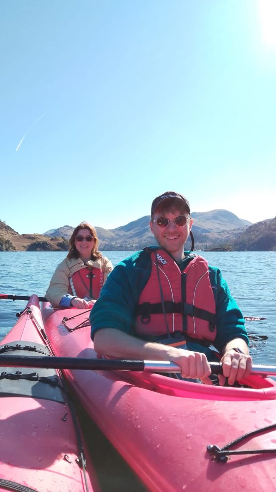 A couple enjoying the beautiful rolling hills of Ullswater on a Lake District Kayaking Tour
