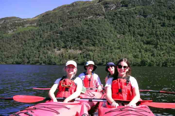 Paddlers enjoying a scenic canoeing experience on Ullswater with Tall Bloke Adventures.